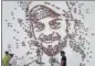  ?? AFP ?? A mural of Kohli’s face using cricket balls in Mumbai.