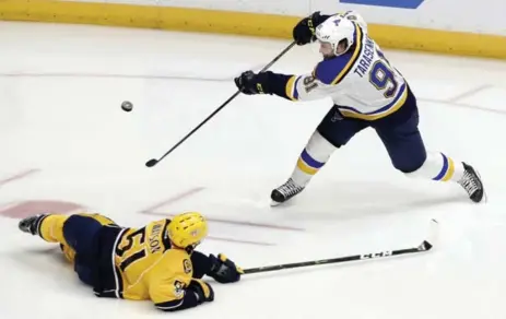  ?? MARK HUMPHREY/THE ASSOCIATED PRESS ?? Predators forward Austin Watson blocks a shot by Vladimir Tarasenko of the Blues in Game 4 of their best-of-seven series in Nashville.