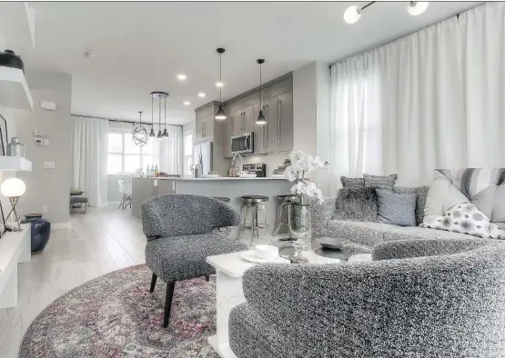  ?? PHOTOS: TRUMAN HOMES ?? A main living floor that allows space but is still connected — that’s Truman Homes’ concept for Yorke Townhomes in Cornerston­e.