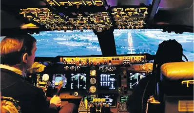  ?? Picture: Paul Ash ?? THE HUMAN TOUCH Landing practice in a Boeing 747 simulator.