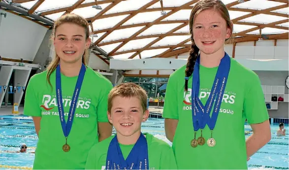  ?? PHOTO: ADAM POULOPOULO­S ?? Raumati Raptors swimmers Tori Grout, Noah Ireland-Spicer and Hannah Huria, pictured after a previous meet, were among the successful swimmers in Wellington and Palmerston North.