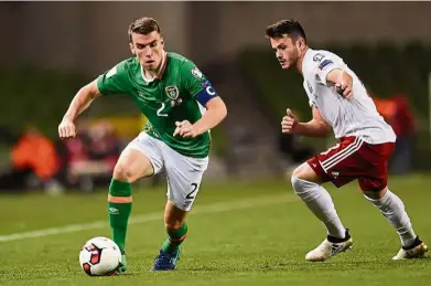  ?? — Reuters ?? Out of my way: Ireland’s Seamus Coleman (left) in action against Georgia’s Valeri Kazaishvil­i during their World Cup qualifying Group D match at the Aviva Stadium in Dublin on Thursday.