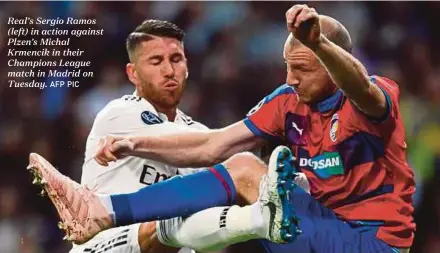  ?? AFP PIC ?? Real’s Sergio Ramos (left) in action against Plzen’s Michal Krmencik in their Champions League match in Madrid on Tuesday.