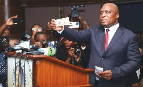  ?? — Picture: Believe Nyakudjara ?? Reserve Bank of Zimbabwe Governor Dr John Mushayavan­hu unveils the country’s new currency, ZiG, during presentati­on of the 2024 Monetary Policy Statement in Harare on Friday