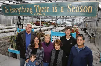  ?? BILL LACKEY / STAFF ?? Several generation­s of the Cappelli family gather in a Cappelli’s Country Garden greenhouse on East Leffel Lane last week. The Cappelli family is auctioning off nearly 200 acres of farmland that has been in their family for almost 100 years.