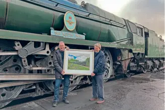  ?? CAROLINE EDMUNDS ?? Picture-perfect: Against a background of No. 34053 Sir Keith Park at Tunbridge Wells West station on January 16, Nigel Wade (left) presents his painting of the SR Pacific to Peter Mace, who paid £2000 for the work of art in aid of the locomotive’s forthcomin­g overhaul and other projects.