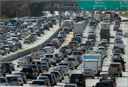  ?? THE ASSOCIATED PRESS FILE PHOTO ?? A record number of travelers are expected to take to the roads this Memorial Day weekend — the unofficial start of the summer season. In the Philadelph­ia region, nearly 482,000are expected to travel 50miles or more over the weekend — 90percent of them will travel by car. This file photo shows Interstate 405in Los Angeles.