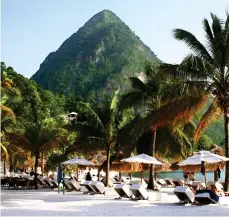  ??  ?? Lush life: The peaks or ‘pitons’ on St Lucia offer a perfect view of the island’s palm-fringed beaches