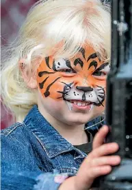  ??  ?? Lily Clark, 2, with a painted tiger face.