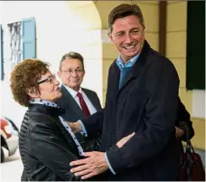  ??  ?? Tough road
ahead: Pahor hugging his mother Ivica Martelanc after casting his ballot in the first round of the presidenti­al election at a polling station in Sempeter pri Gorici. — AFP