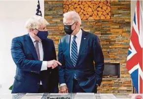  ?? EPA PIC ?? Britain’s Prime Minster Boris Johnson gestures to US President Joe Biden (right) as they look at the Atlantic charter during their bilateral meeting in Carbis Bay, Britain on Thursday.