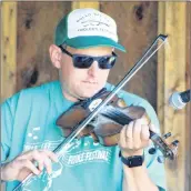  ?? KATHERINE HUNT/THE GUARDIAN ?? Brad Chaisson plays his fiddle with The Chaisson Family during this year’s Rollo Bay Fiddle Festival.