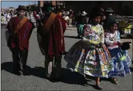  ?? AP/JUAN KARITA ?? Girls wearing costumes made from recycled plastic milk bags attend a student festival Tuesday in El Alto, Bolivia. They and classmates were raising environmen­tal awareness.