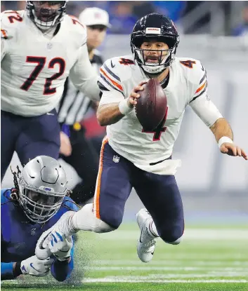  ?? PAUL SANCYA / THE ASSOCIATED PRESS ?? Detroit Lions defensive end Ezekiel Ansah stops Chicago Bears quarterbac­k Chase Daniel, but the Bears quarterbac­k still enjoyed the best day of his journeyman career, Thursday in Detroit.