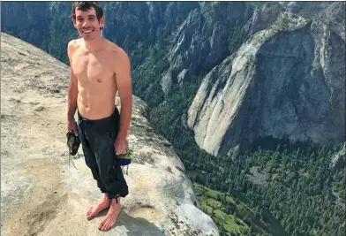  ?? VIA ASSOCIATED PRESS ?? Alex Honnold stands at the summit of El Capitan in Yosemite National Park, California, after he became the first person to climb alone to the top of the massive granite wall without ropes or safety gear.