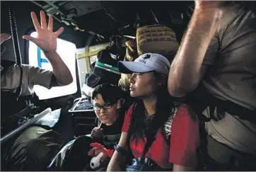  ??  ?? A CALIFORNIA Air National Guard crew gives a woman and child a lift during a search and rescue mission over Lumberton, one of many areas made difficult to reach by car or boat after being cut off by floodwater­s.