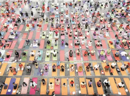  ?? Mayra Beltrán photos / Houston Chronicle ?? About 2,000 people participat­e in a yoga session at Houston’s first Internatio­nal Day of Yoga at the George R. Brown Convention Center.