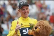  ?? CHRISTOPHE ENA — THE ASSOCIATED PRESS ?? Britain’s Chris Froome, wearing the overall leader’s yellow jersey, flashes a thumbs up on the podium after the twentieth stage of the Tour de France cycling race, an individual time trial over 22.5 kilometers (14 miles) with start and finish in...