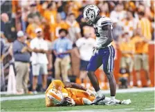  ?? ?? Tennessee wide receiver Cedric Tillman lies on the field after being hit by Akron cornerback Tyson Durant during the first half Saturday night at Neyland Stadium. Tillman walked off without assistance.