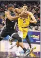  ?? Ezra Shaw Getty Images ?? THE LAKERS’ Talen Horton-Tucker guards the Kings’ Terence Davis.