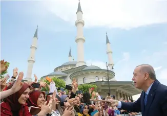  ?? (Kayhan Ozer/Reuters) ?? TURKISH PRESIDENT Recep Tayyip Erdogan is greeted by his supporters last week as he leaves a mosque after Friday prayers in Ankara.
