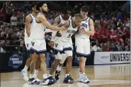  ?? DAVID J. PHILLIP — THE ASSOCIATED PRESS ?? Villanova guard Justin Moore (5) is helped off the floor during the second half of the Wildcats’ victory over Houston Saturday night in San Antonio.