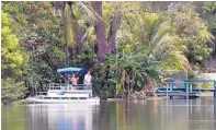  ?? WILFREDO LEE/ASSOCIATED PRESS ?? A couple stand in a pontoon boat on one of the lakes at Silver Lakes Rotary Nature Park in Davie, Fla., on Friday, after a woman was attacked by an alligator in the park.