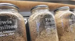  ?? RICKY CARIOTI/THE WASHINGTON POST ?? Jars with the names and dates of lynching victims and the soil from the sites where they were lynched are on display at the Legacy Museum in Montgomery, Ala.