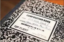  ?? ALYSSA POINTER/ALYSSA.POINTER@AJC.COM ?? While Zach was in a coma, friends would visit and write down their get well wishes in this notebook.