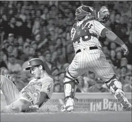  ?? Chris Sweda Chicago Tribune ?? CODY BELLINGER scores for the Dodgers ahead of a tag by Willson Contreras of the Chicago Cubs in the sixth inning of the second game of a doublehead­er.