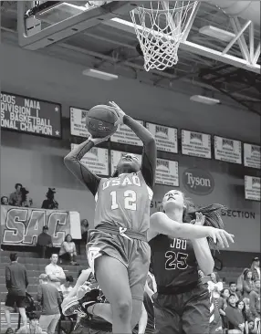  ?? Matthew Christense­n/JBU Sports Informatio­n ?? Science and Arts guard Dierra Ely fights off John Brown’s Preslea Reece for a shot attempt Friday during the semifinals of the Sooner Athletic Conference Tournament at Bill George Arena.