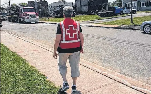  ?? PHOTO COURTESY OF THE CANADIAN RED CROSS ?? Canadian Red Cross volunteer Anne Tremblett works the front lines at the Froude Avenue fire.