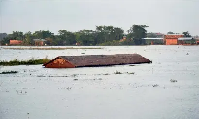  ?? PTI ?? An inundated village at Suprakandh­i in flood-hit Karimganj district of Assam on Sunday. —