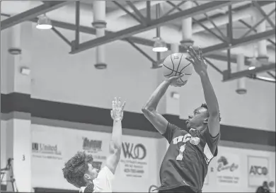  ?? Steven Eckhoff ?? Unity Christian’s Jay Davis takes a shot over Trion’s Josh Cornett in Saturday’s NWGA Tip-off Club boys all-star game at Georgia Highlands College. Davis scored 15 points in the contest.