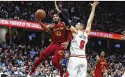  ?? RON SCHWANE / AP ?? Cavaliers guard Donovan Mitchell drives to the basket Monday in Cleveland. Mitchell scored or assisted on 99 points in the game, the second most in a game in NBA history behind Wilt Chamberlai­n in his 100-point game on March 2, 1962 (104).