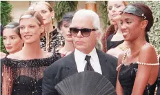  ?? PIERRE VERDY/AFP/GETTY IMAGES ?? Canadian model Linda Evangelist­a, left, designer Karl Lagerfeld and British model Naomi Campbell at Chanel’s fall/winter 1996-1997 collection in Paris.