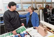  ?? Arnold Gold/Hearst Connecticu­t Media ?? Wilbur Cross High School sophomore Joshua Herrera, 16, left, speaks with American Federation of Teachers President Randi Weingarten in the print shop at the school in New Haven on Thursday.