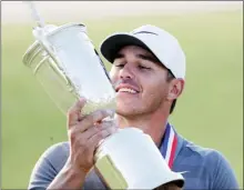  ?? The Associated Press ?? Brooks Koepka holds up the Golf Champion Trophy after winning the U.S. Open Golf Championsh­ip, Sunday in Southampto­n, N.Y.