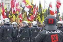  ??  ?? VIENNA: In this file photo police forces stand in front of demonstrat­ors during a rally of the group Austrian protesters against migrants in Vienna, Austria. — AP