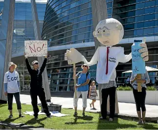  ?? PHOTO: ALDEN WILLIAMS/STUFF ?? Demonstrat­ors performed a ‘‘silent skit’’ outside Christchur­ch’s art gallery to protest against a water bottling plant in the city.