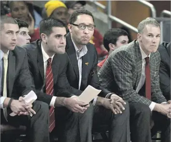  ?? Rick Loomis Los Angeles Times ?? “I DEFINITELY can get the players,” USC associate head coach Tony Bland, with glasses, said during an Aug. 31 on-campus meeting, as recorded by an undercover FBI agent. Head coach Andy Enfield is at right.