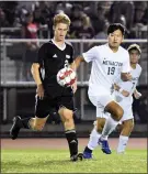  ?? AUSTIN HERTZOG - MNG ?? At left, Boyertown’s Ryan Goffice (8) elevates for a header against Methacton on Sept. 14. At right, Boyertown’s Beckett Wenger gains possession in the midfield as Methacton’s Zach Cho gives chase.