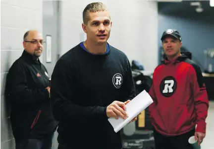  ?? SEAN KILPATRICK/THE CANADIAN PRESS ?? Redblacks GM Marcel Desjardins, left, and head coach Rick Campbell look toward quarterbac­k Trevor Harris ahead of a year-end media availabili­ty on Tuesday. Desjardins said Harris would be the first choice as the team’s pivot next season if he re-signs.