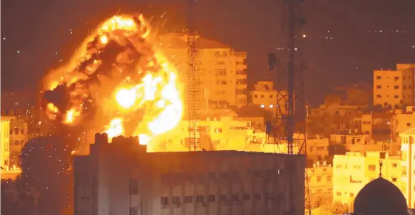  ?? Picture: AFP ?? A ball of fire billows above buildings in Gaza City during reported Israeli strikes as cross-border fighting intensifie­s.