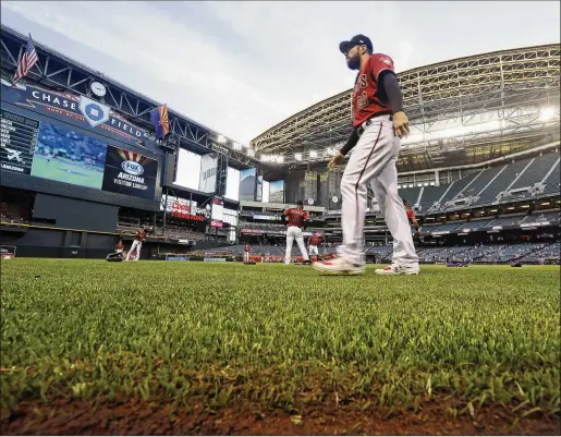  ?? ASSOCIATED PRESS 2019 ?? The Arizona Diamondbac­ks’ Steven Souza Jr. walks on new synthetic grass at Chase Field before a spring training game in Phoenix. The Diamondbac­ks ripped out the grass at the field, replacing it with the artificial turf. The team says they’ve saved about 16 million gallons of water because of it.