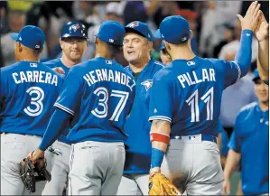  ?? AP PHOTO MICHAEL DWYER ?? Toronto Blue Jays’ Ezequiel Carrera (3), Teoscar Hernandez (37) and Kevin Pillar (11) celebrate with teammates after the Blue Jays defeated the Boston Red Sox 9-4 in a baseball game in Boston, Tuesday.