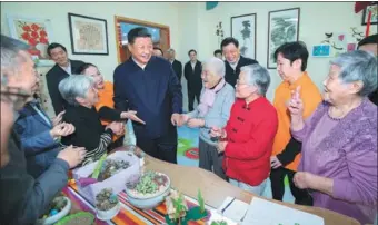  ?? LI TAO / XINHUA ?? President Xi Jinping, also general secretary of the Communist Party of China Central Committee and chairman of the Central Military Commission, greets residents at a community elderly center in Shanghai during his inspection of the city on Tuesday.