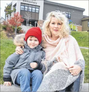  ?? SHARON MONTGOMERY-DUPE/CAPE BRETON POST ?? Yvonne MacKenzie sits on the curb outside St. Anne’s Elementary School in Glace Bay with her son, Devon, 5. MacKenzie said because of a lack of teacher assistants at the school, she has kept her son home for several weeks now, with no word yet on when...