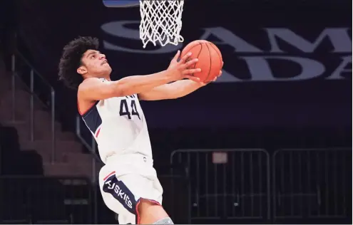  ?? Porter Binks / Getty Images ?? UConn’s Andre Jackson goes up for a dunk against DePaul during the Big East quarterfin­als on March 11 in New York.