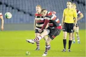  ??  ?? Man of the match Kieran Gammie kicks for goal